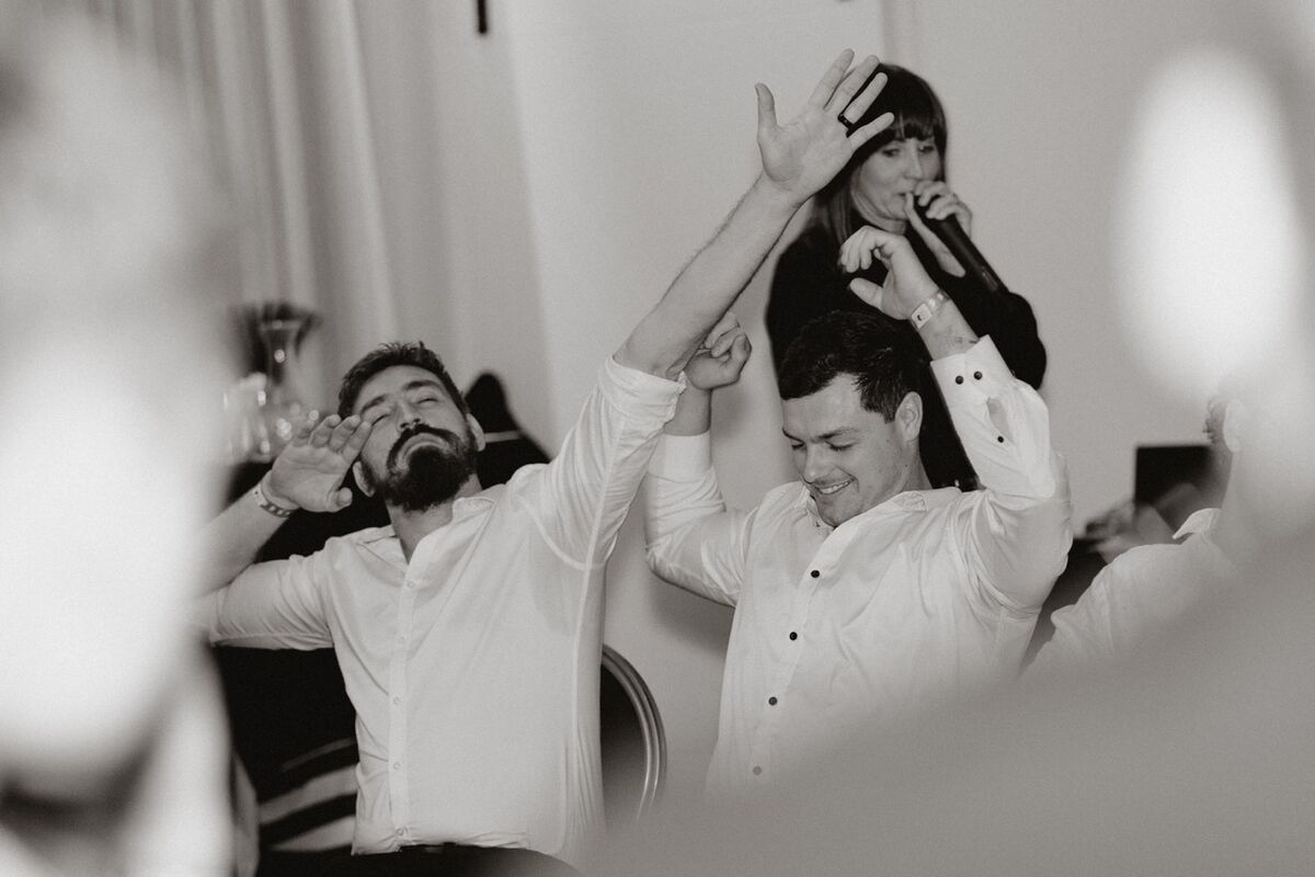 Audience members in hypnosis laughing on stage